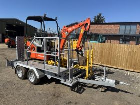 Image of a used Kubota KX015-4 With Indespension Utility trailer